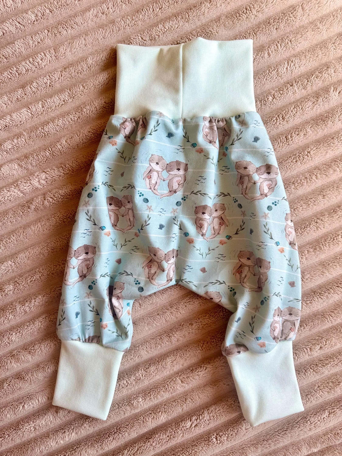 Nahaufnahme Pumphose Baby Größe 74 mit türkisem Bauchbündchen und Otter-Muster