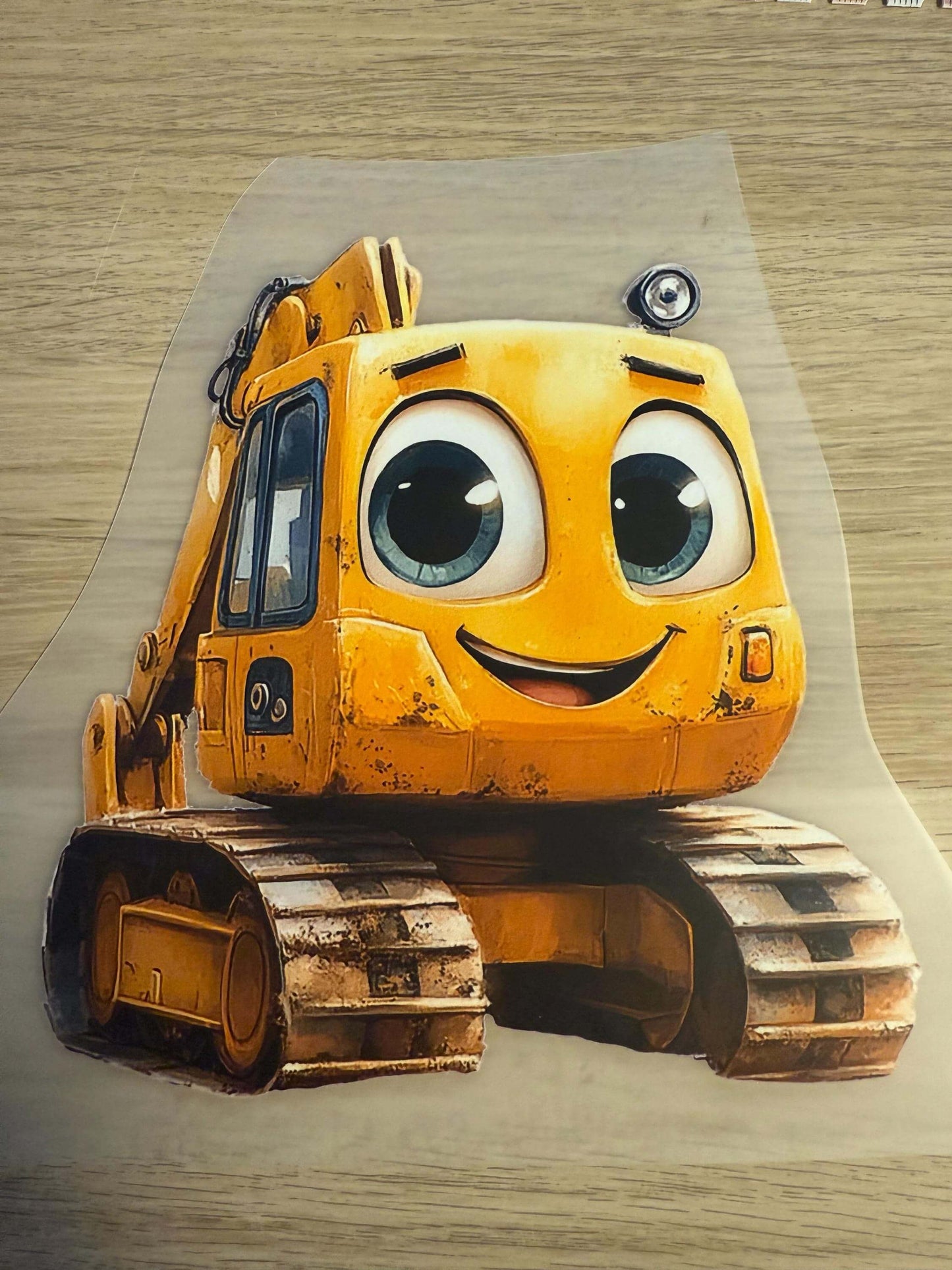 Buegelbild Bagger Motiv mit Raupenketten und freundlichem Gesicht