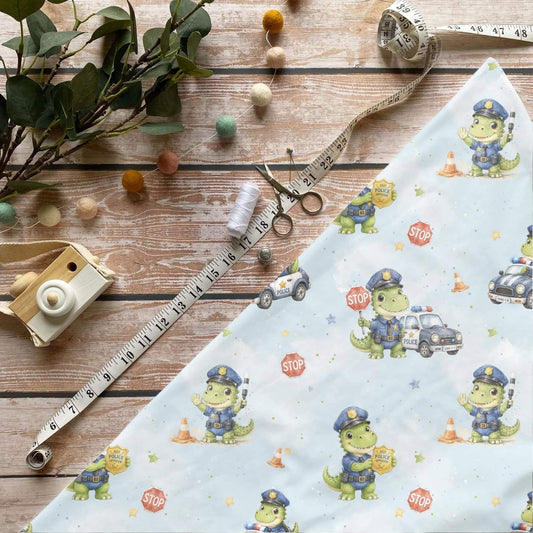 Dino im Einsatz Kinderstoff Meterware mit Polizei Dino und Streifenwagen Motiv, OEKO-TEX 100 Jersey Stoff für Baby- und Kindermode