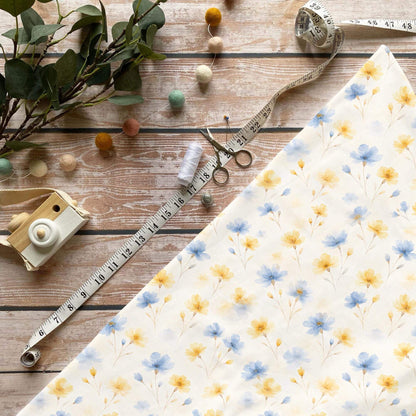 Sommerblüten Stoff Meterware mit zarten gelben und blauen Aquarellblumen auf hellem Hintergrund
